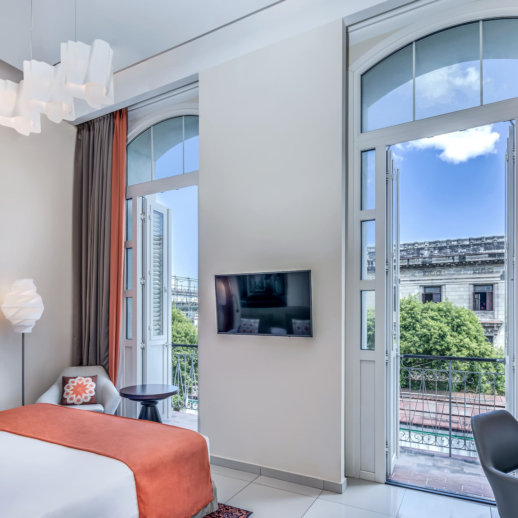 a bedroom with a bed and a television