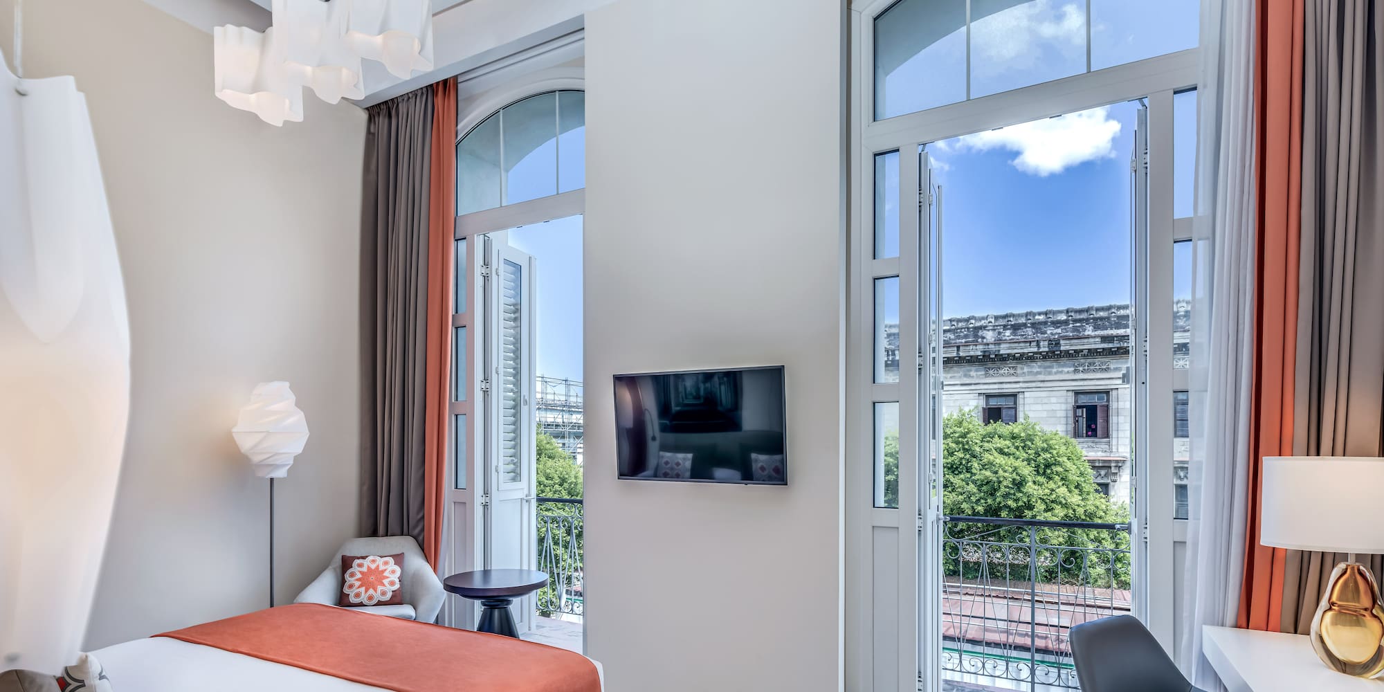 a bedroom with a bed and a television