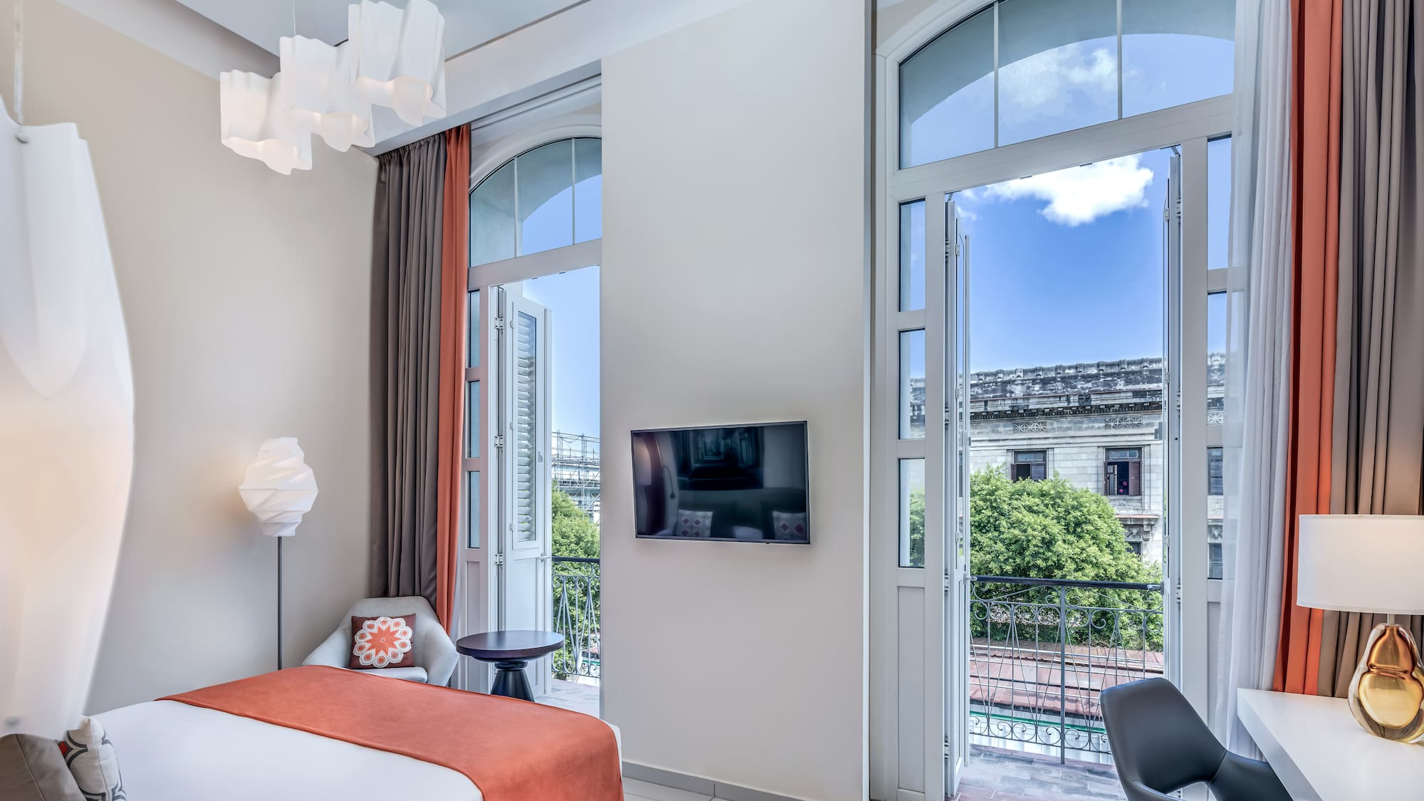 a bedroom with a bed and a television