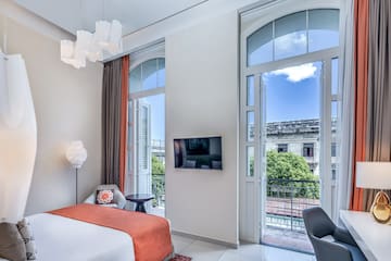 a bedroom with a bed and a television