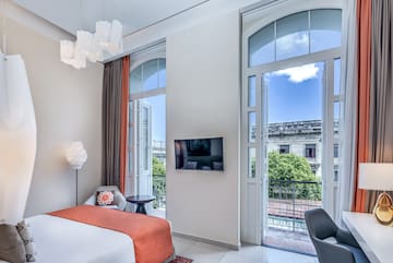 a bedroom with a bed and a television