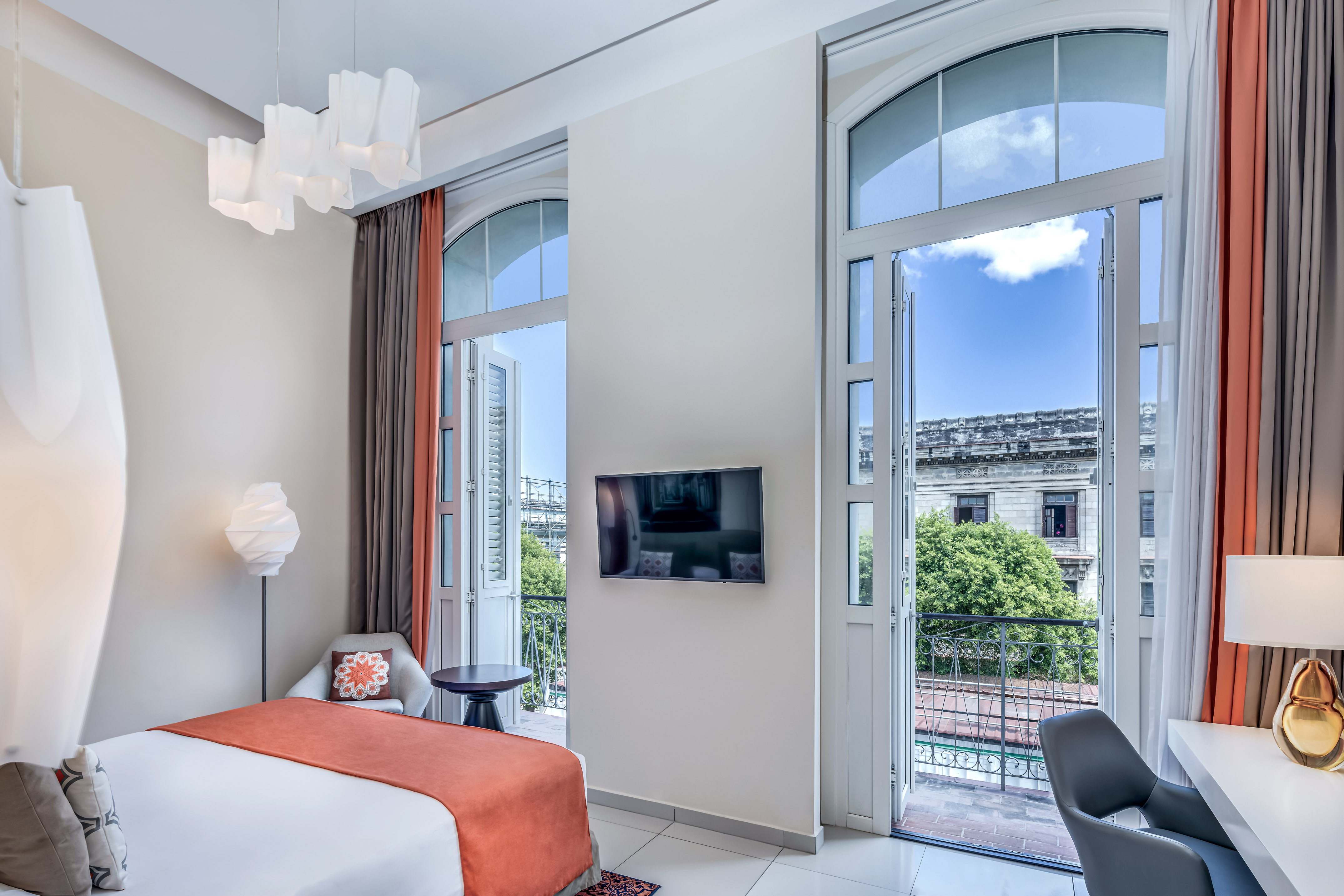 a bedroom with a bed and a television