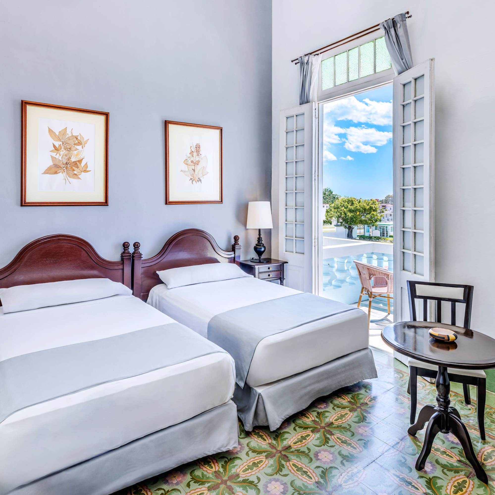 a room with two beds and a table