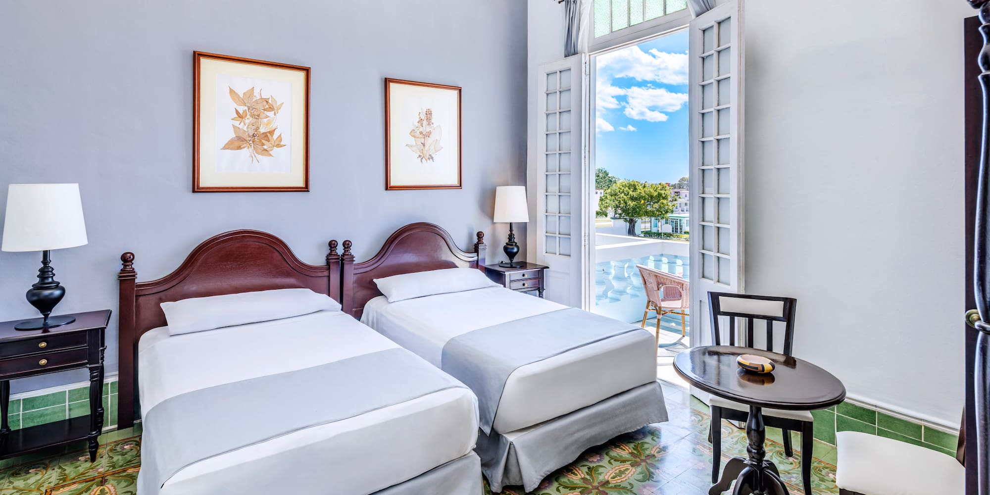 a room with two beds and a table