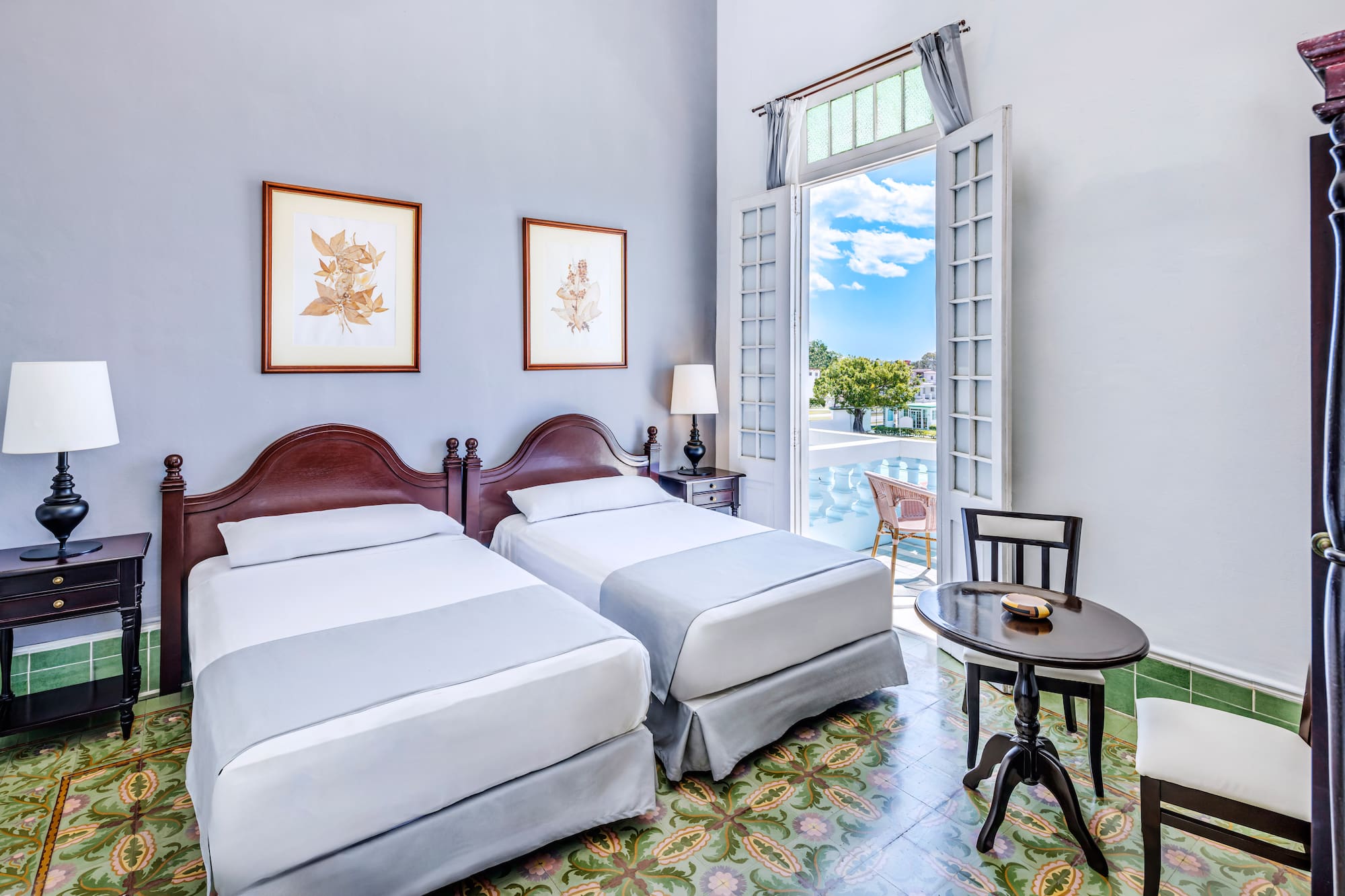 a room with two beds and a table