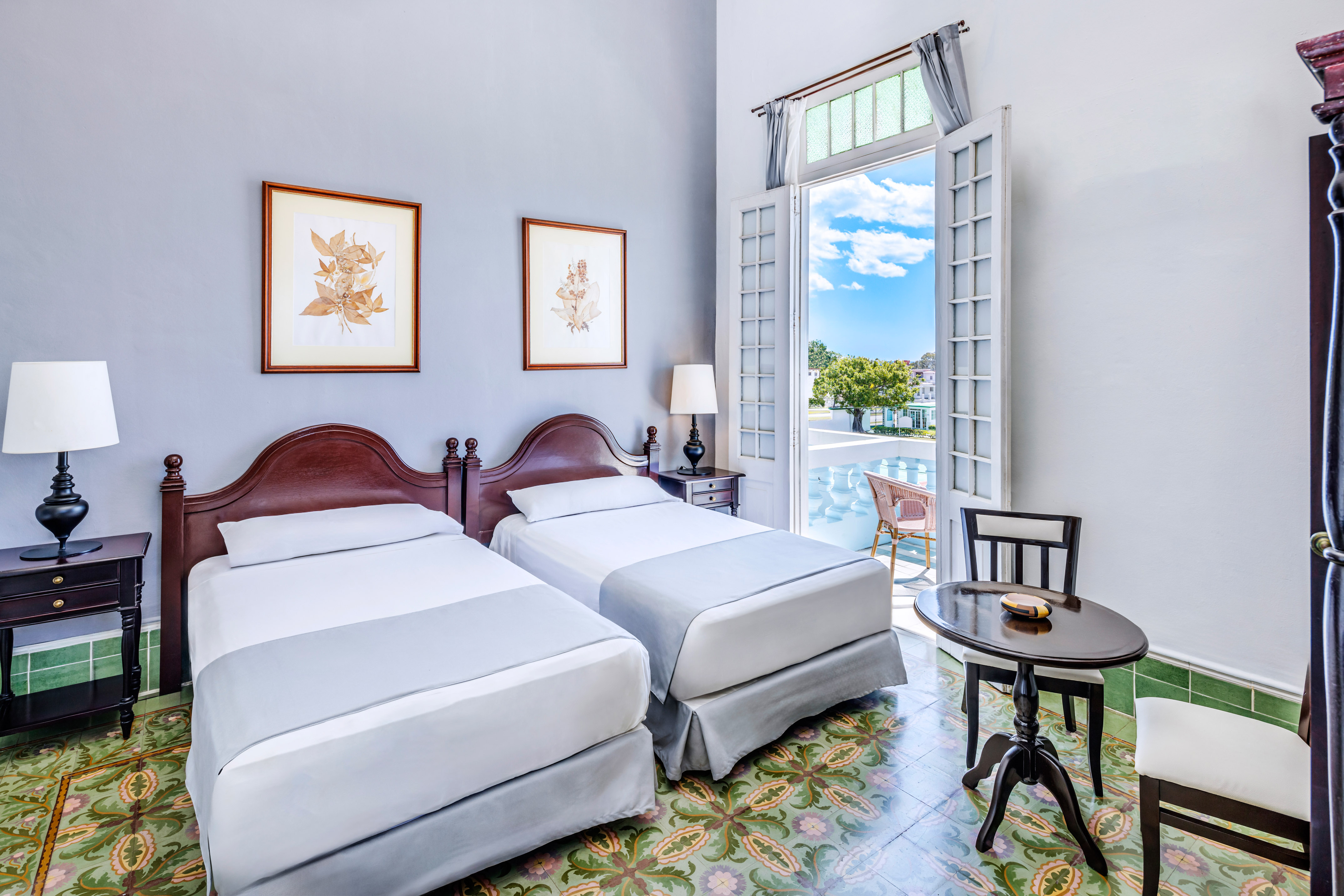 a room with two beds and a table