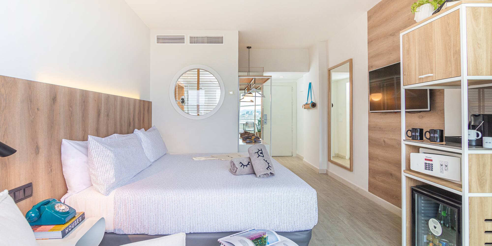 a bedroom with a bed and a mirror