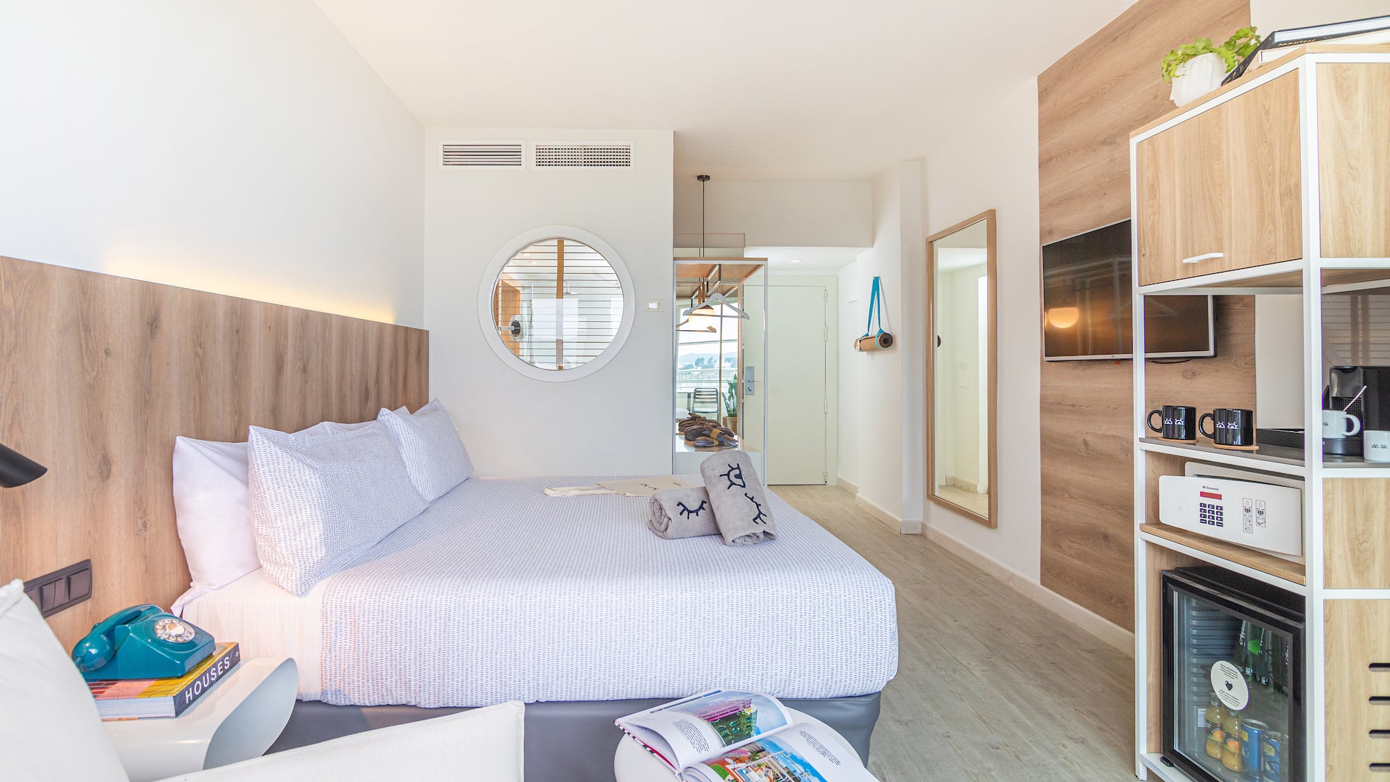 a bedroom with a bed and a mirror