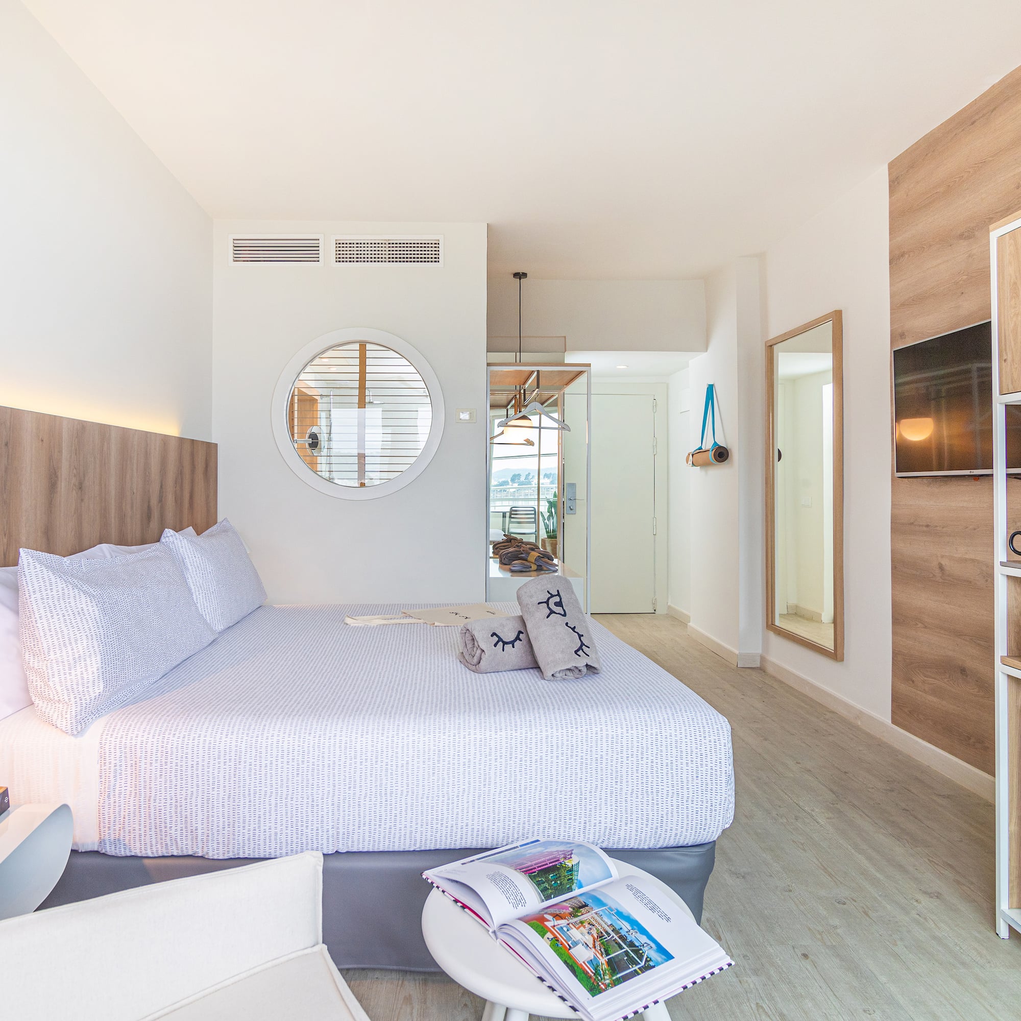 a bedroom with a bed and a mirror