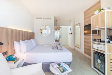 a bedroom with a bed and a mirror