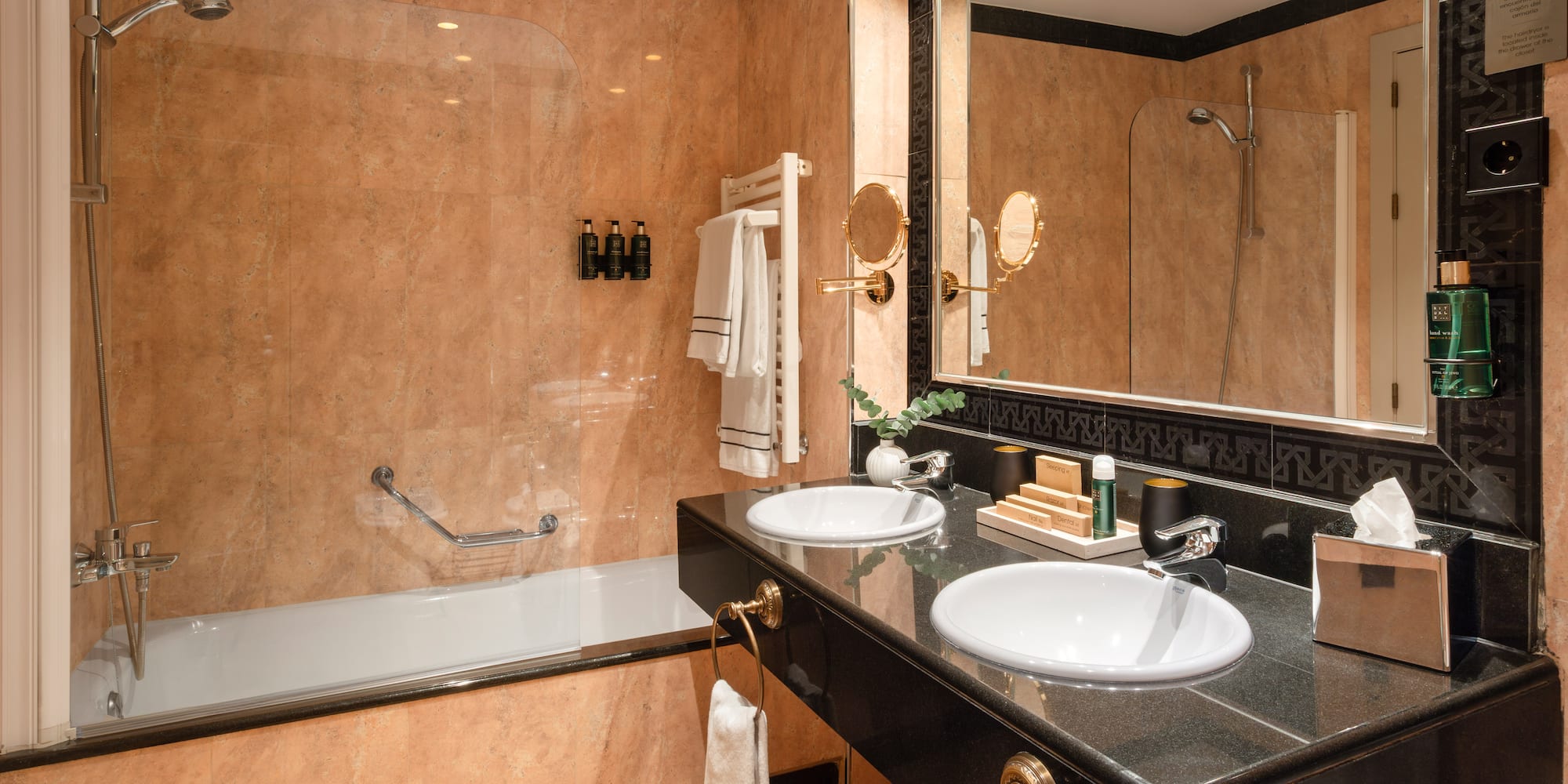 a bathroom with a black countertop and a shower