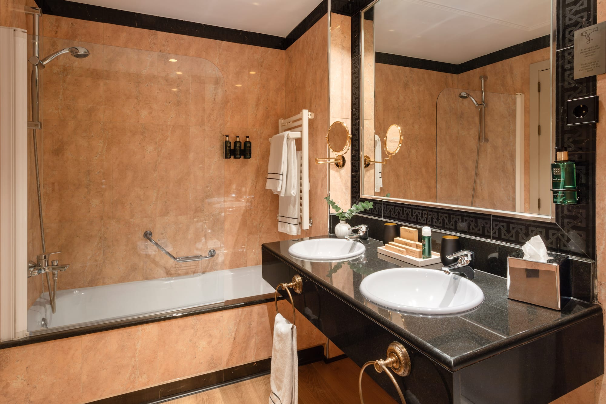 a bathroom with a black countertop and a shower