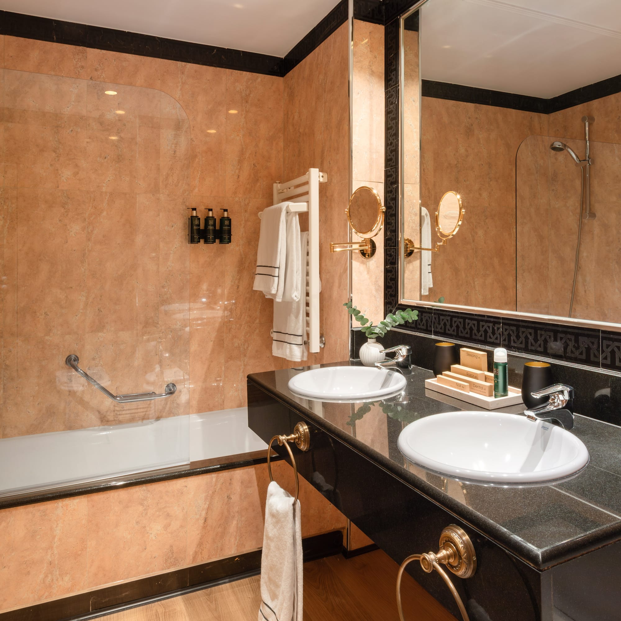 a bathroom with a black countertop and a shower