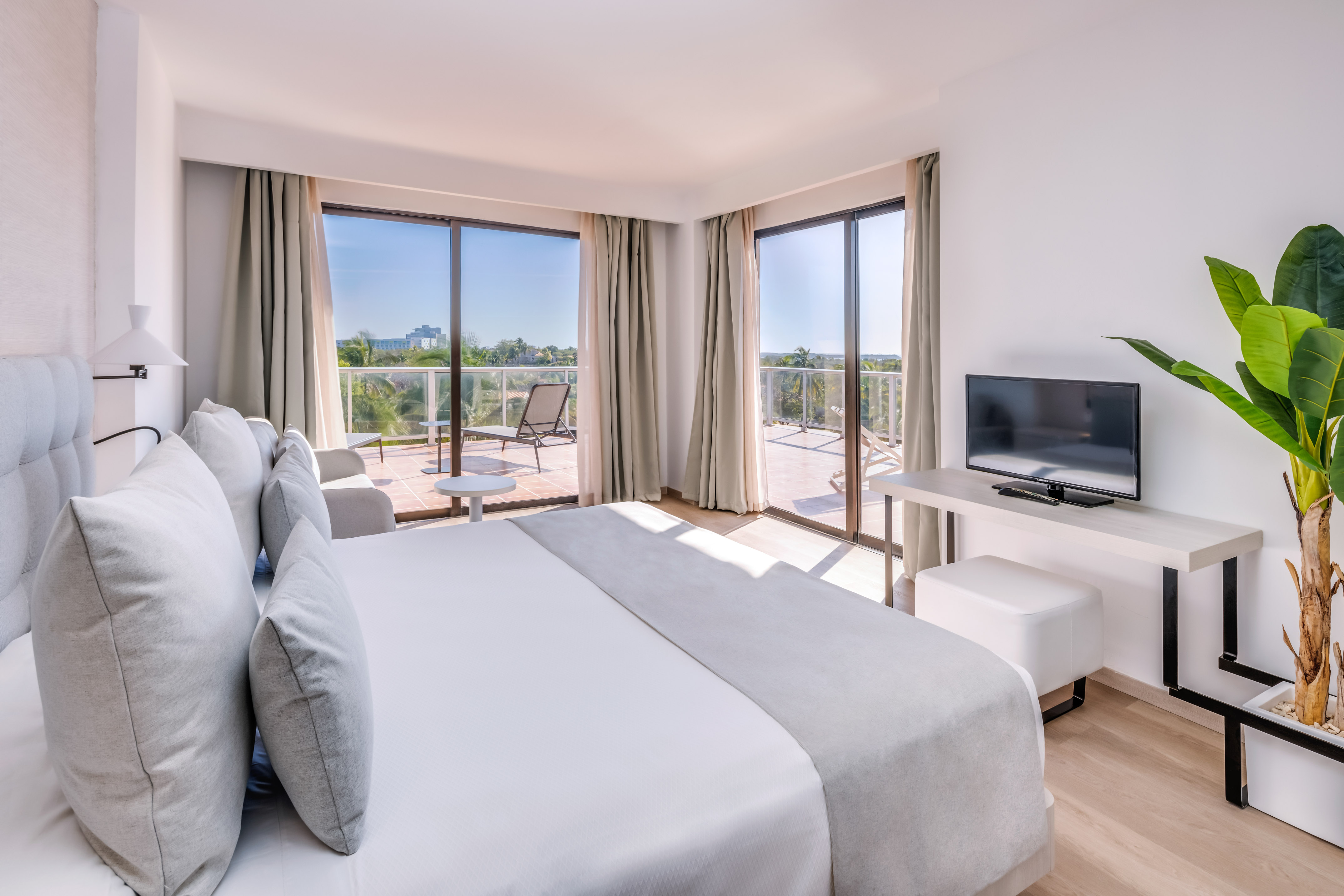 a bedroom with a television and a bed