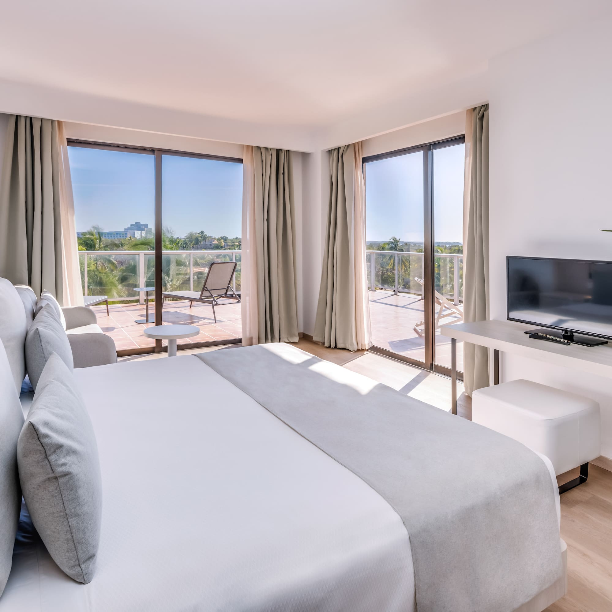 a bedroom with a television and a bed