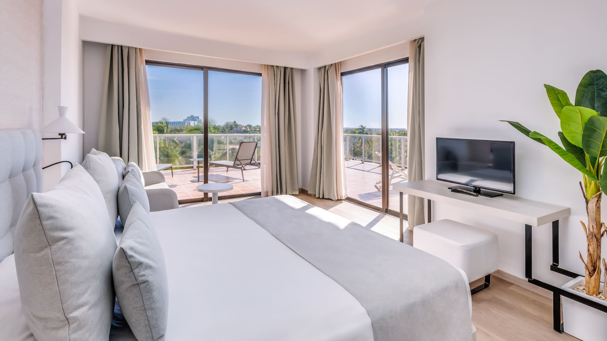 a bedroom with a television and a bed