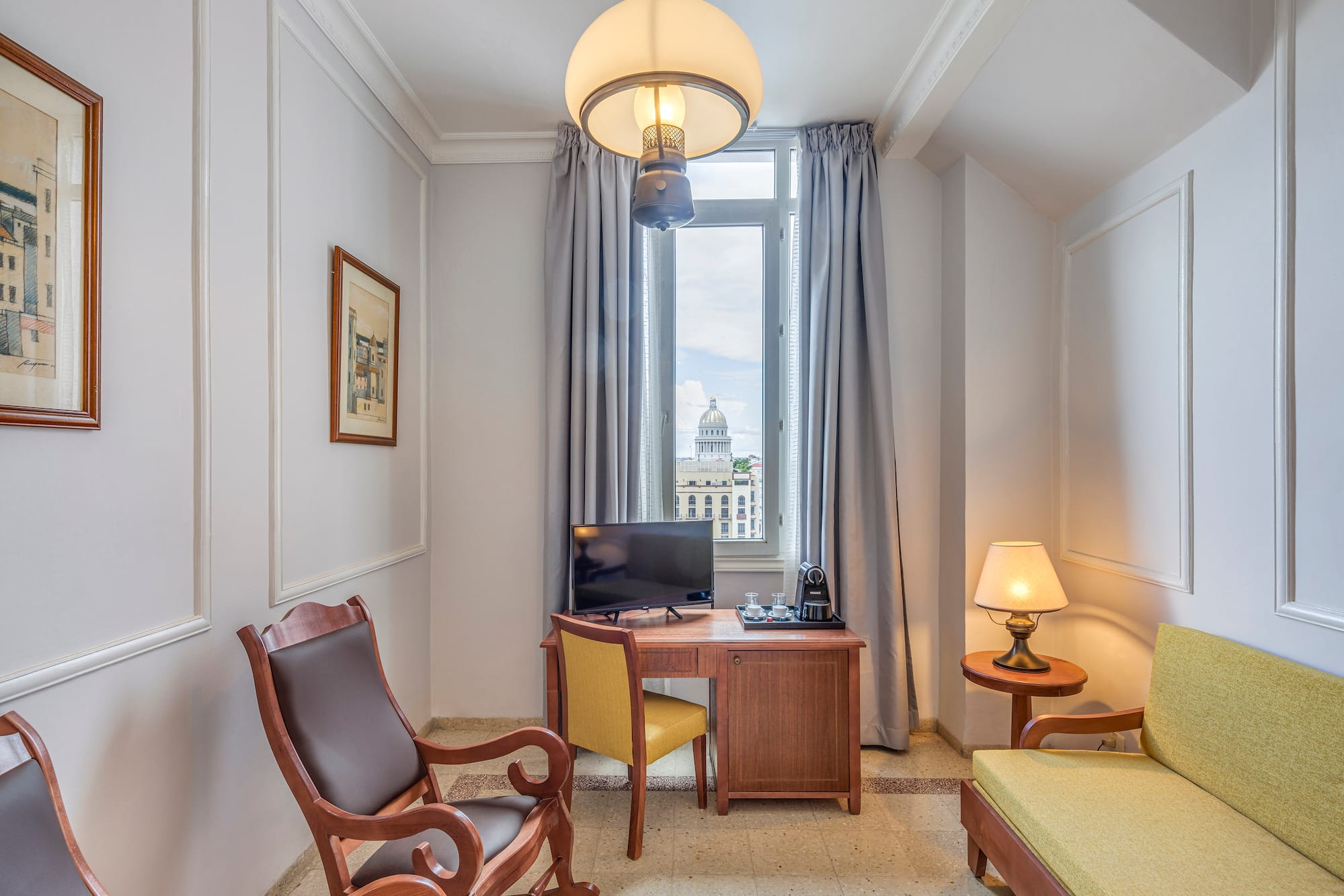 a room with a desk and chairs