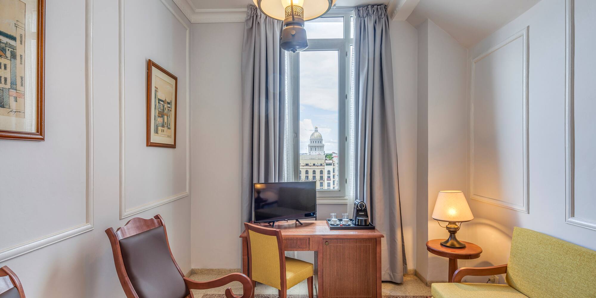 a room with a desk and chairs