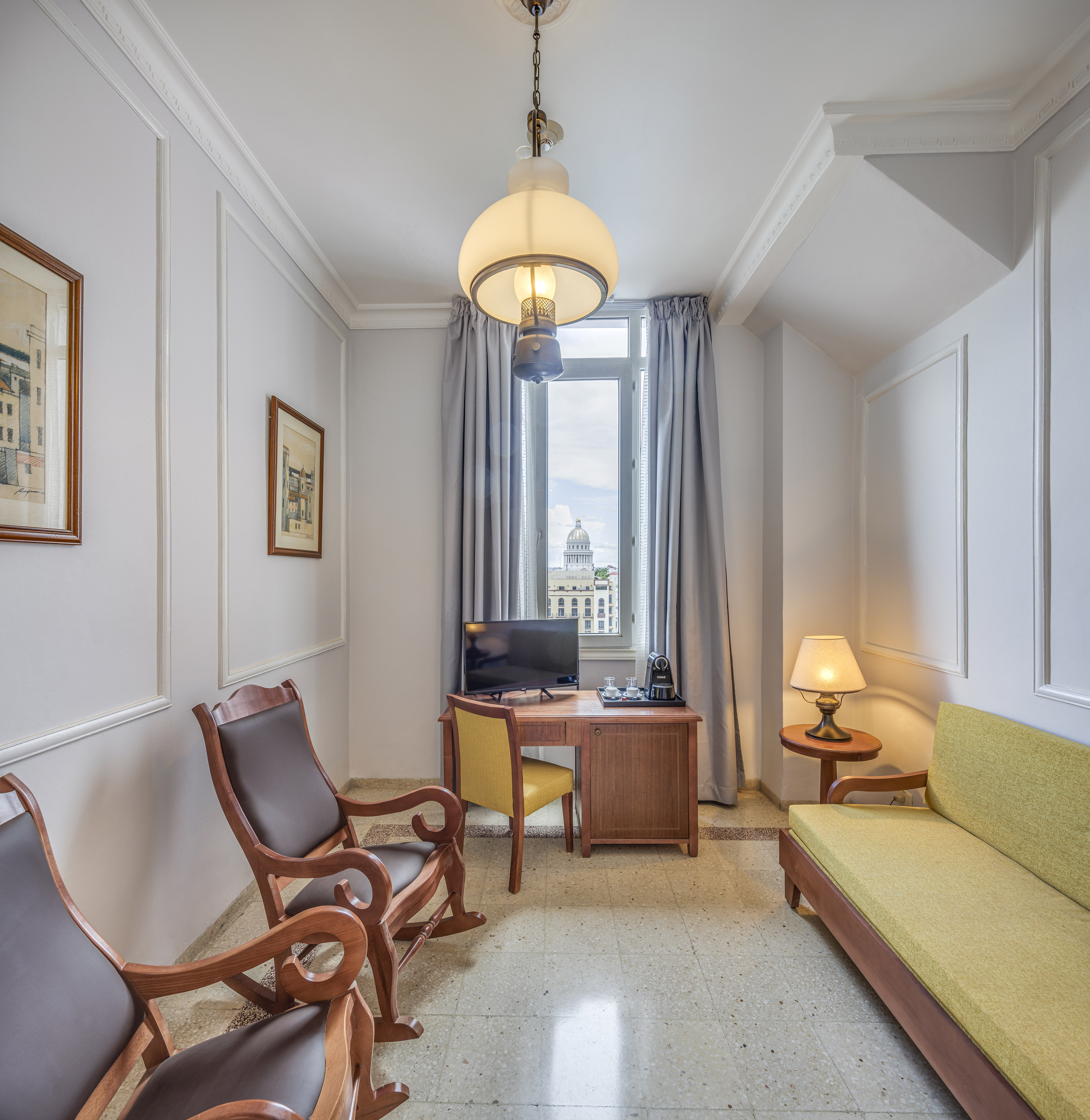 a room with a desk and chairs