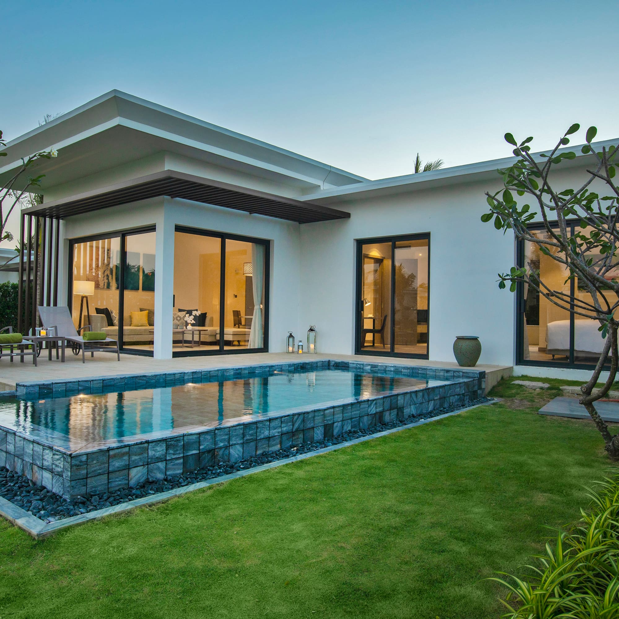 a house with a pool and a lawn