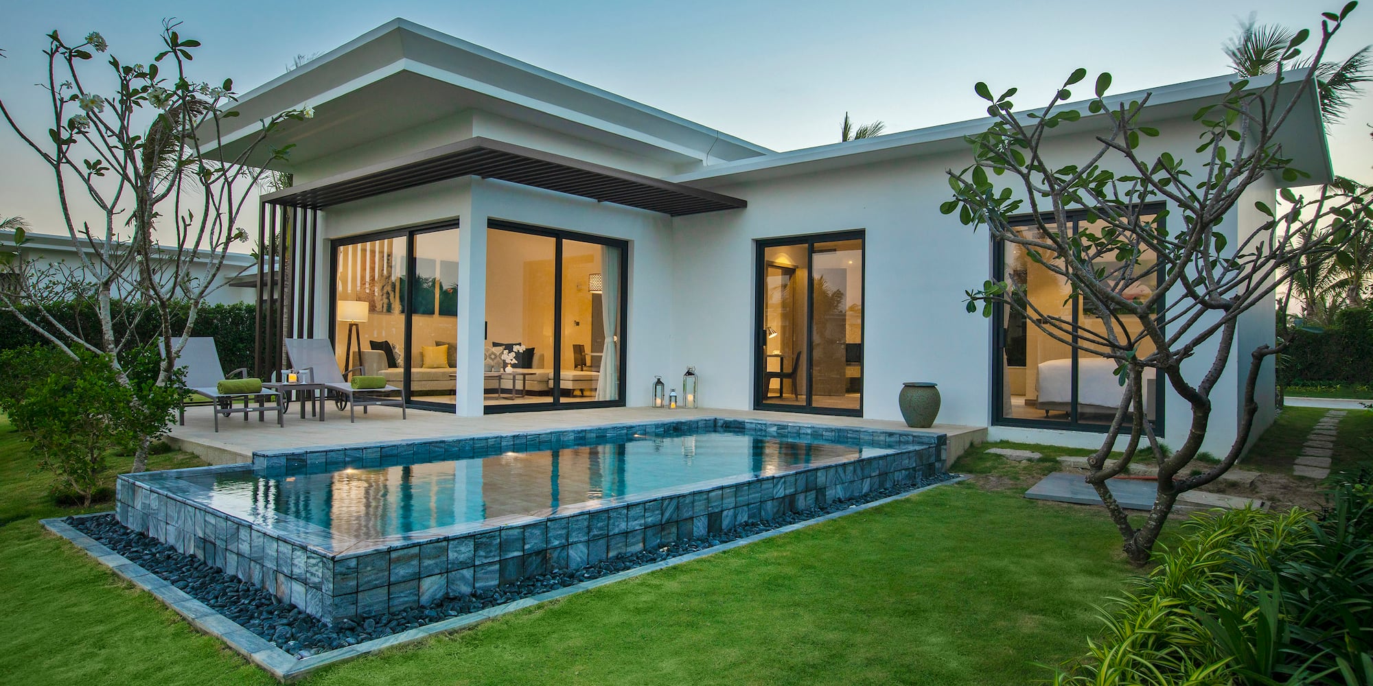 a house with a pool and a lawn