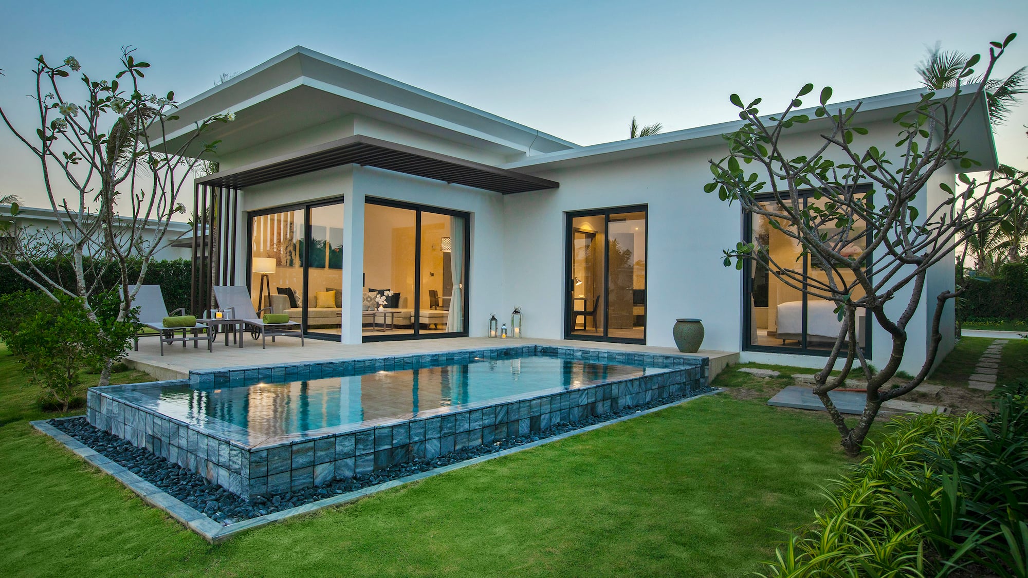 a house with a pool and a lawn