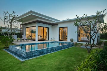 a house with a pool and a lawn