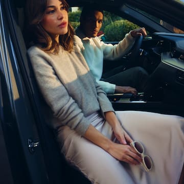 a man and woman sitting in a car