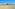 a beach with buildings and sand