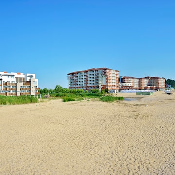 a beach with buildings and sand