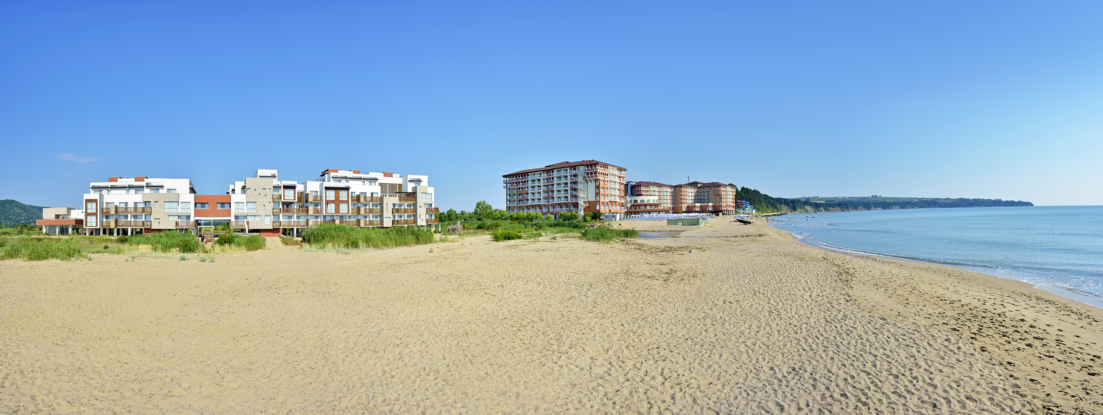 a beach with buildings and sand