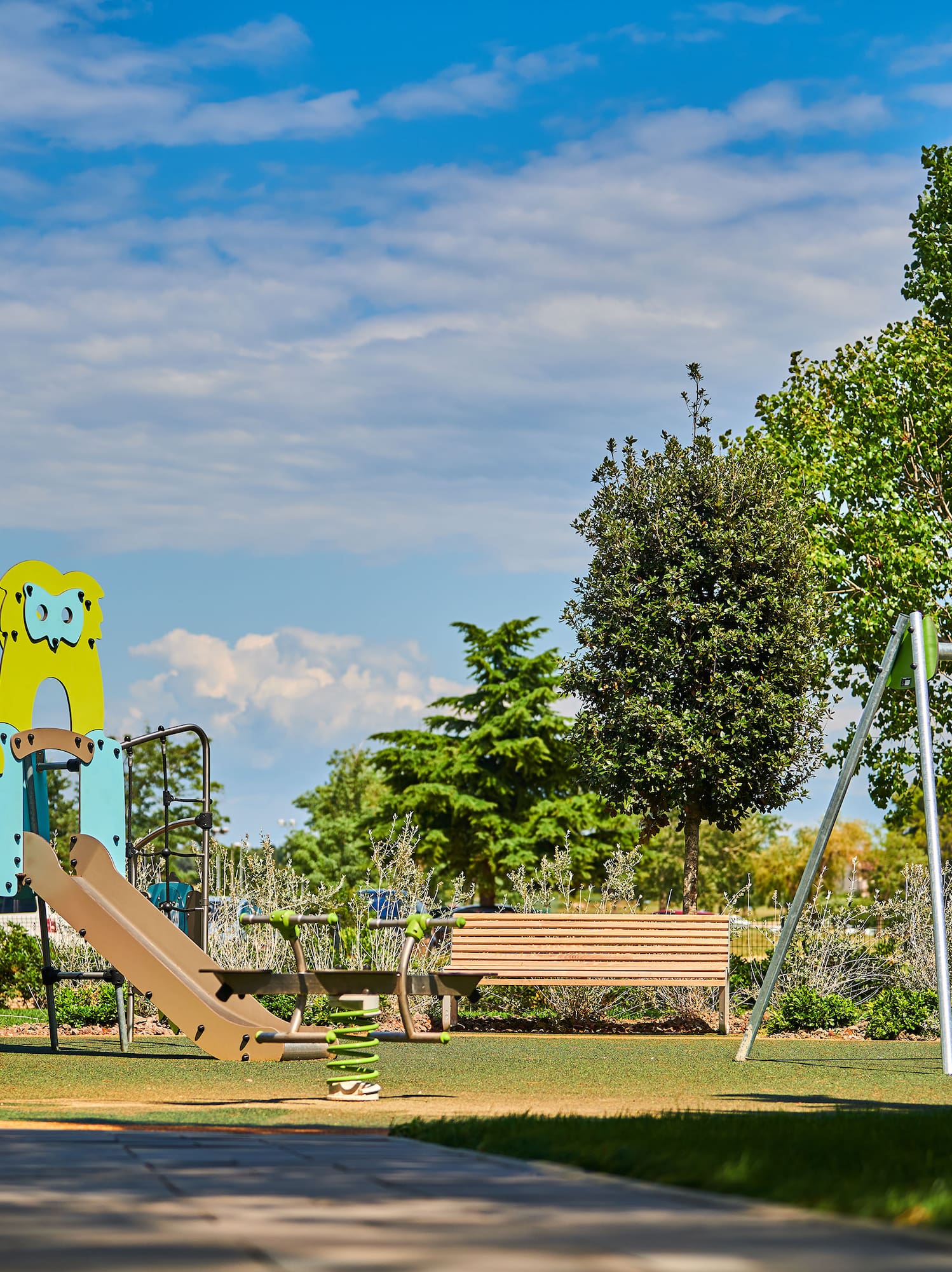 a playground with a slide and a bench