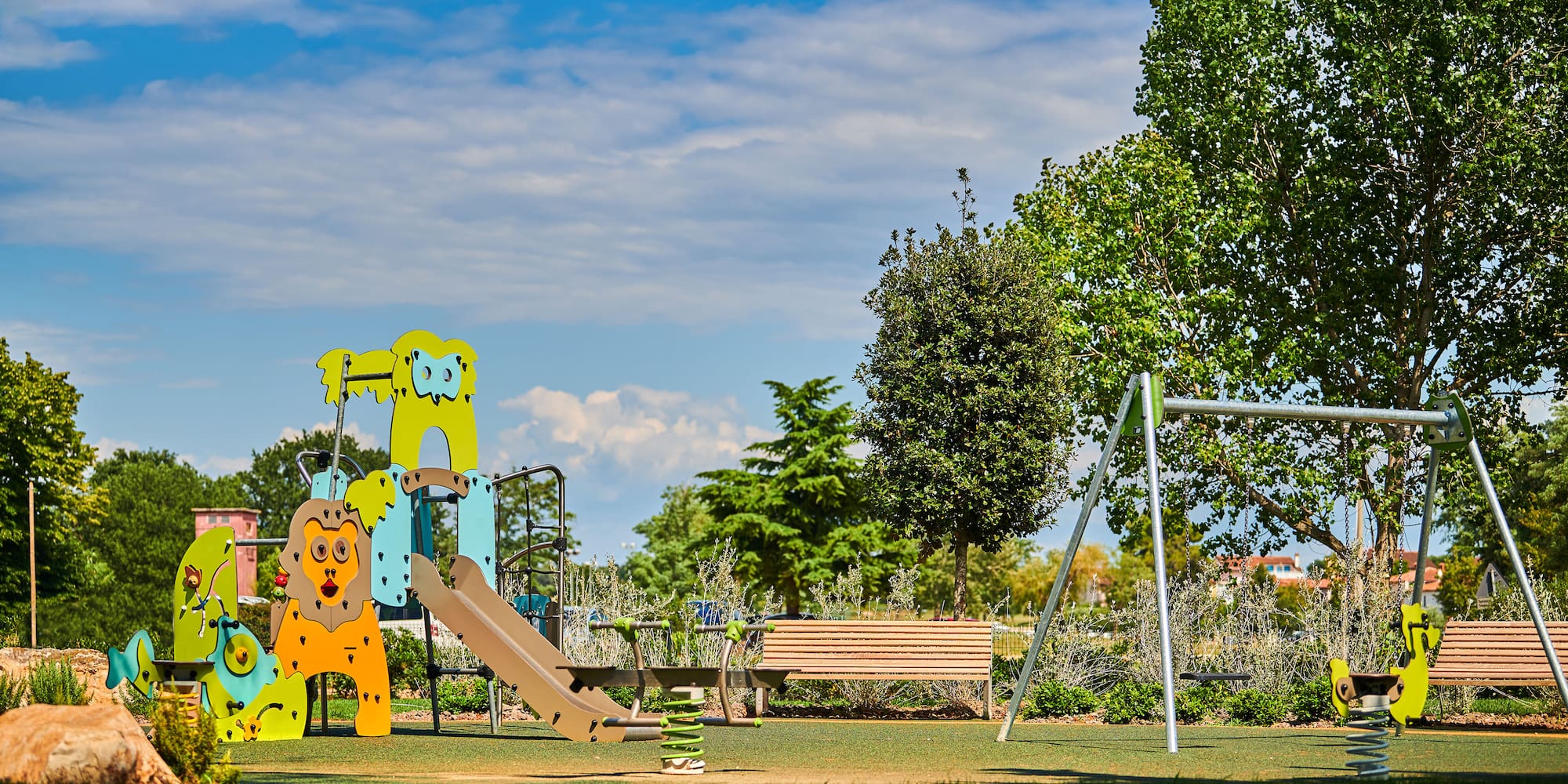a playground with a slide and a bench