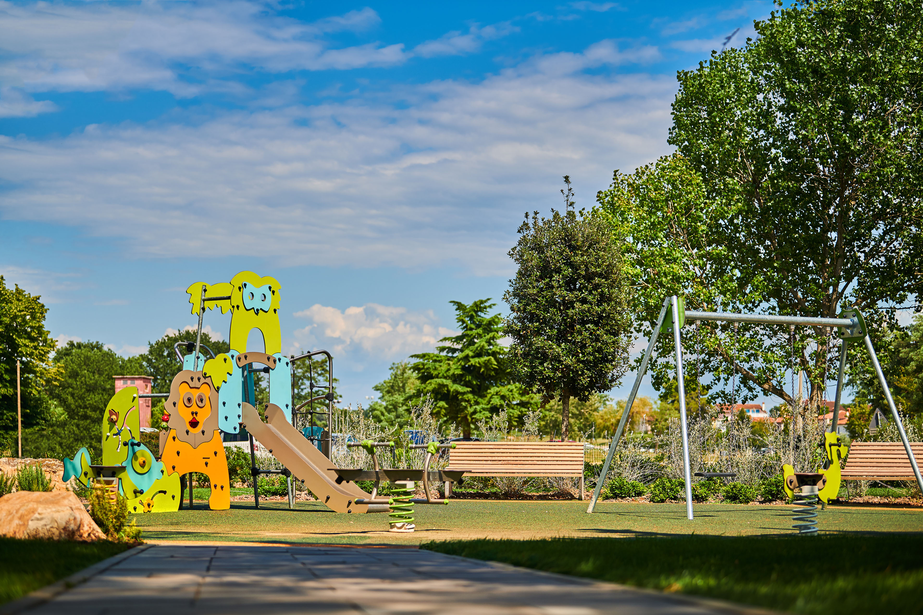 a playground with a slide and a bench