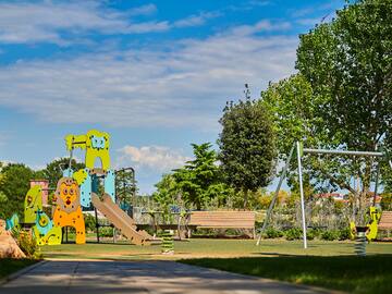 a playground with a slide and a bench