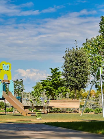 a playground with a slide and a bench