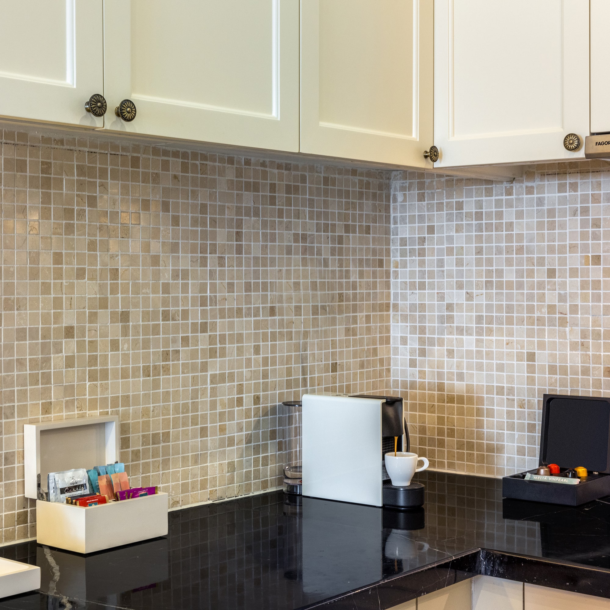 a kitchen with a black counter top