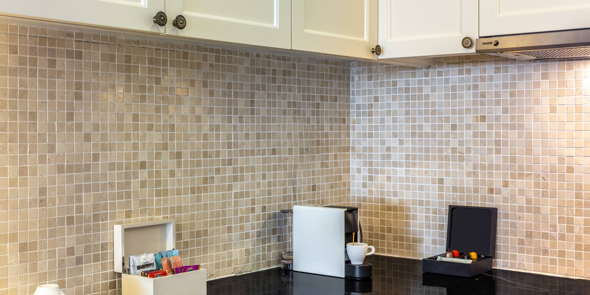 a kitchen with a black counter top