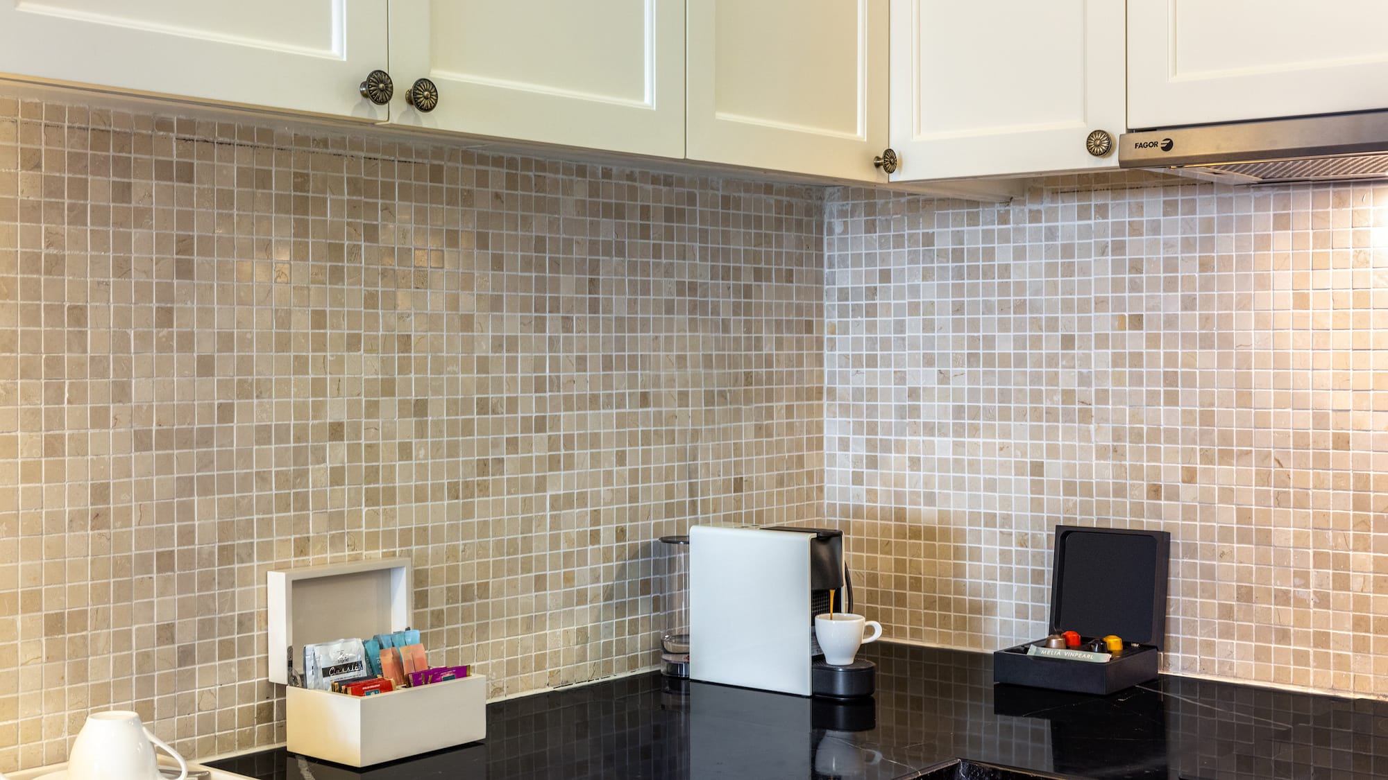 a kitchen with a black counter top