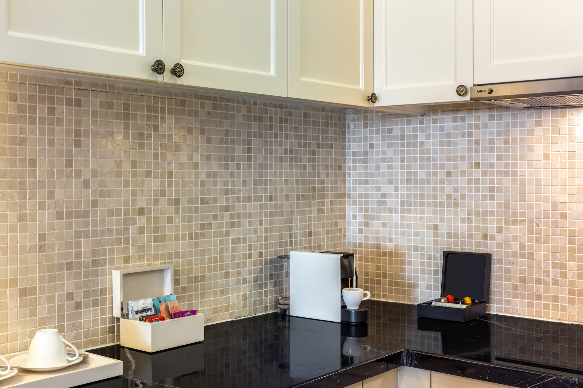 a kitchen with a black counter top