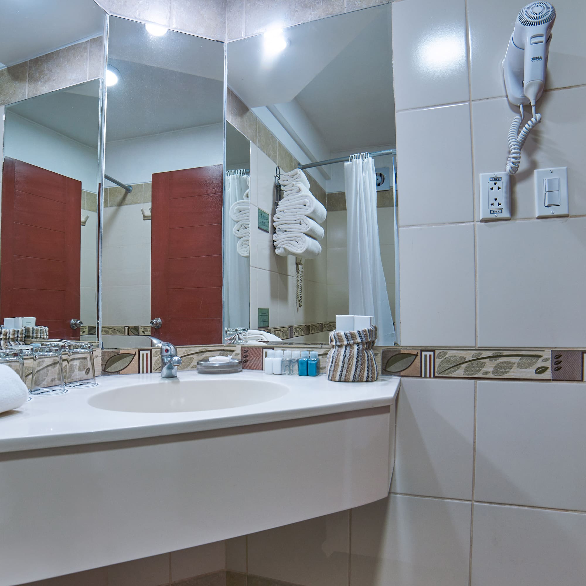 a bathroom with a mirror and a sink