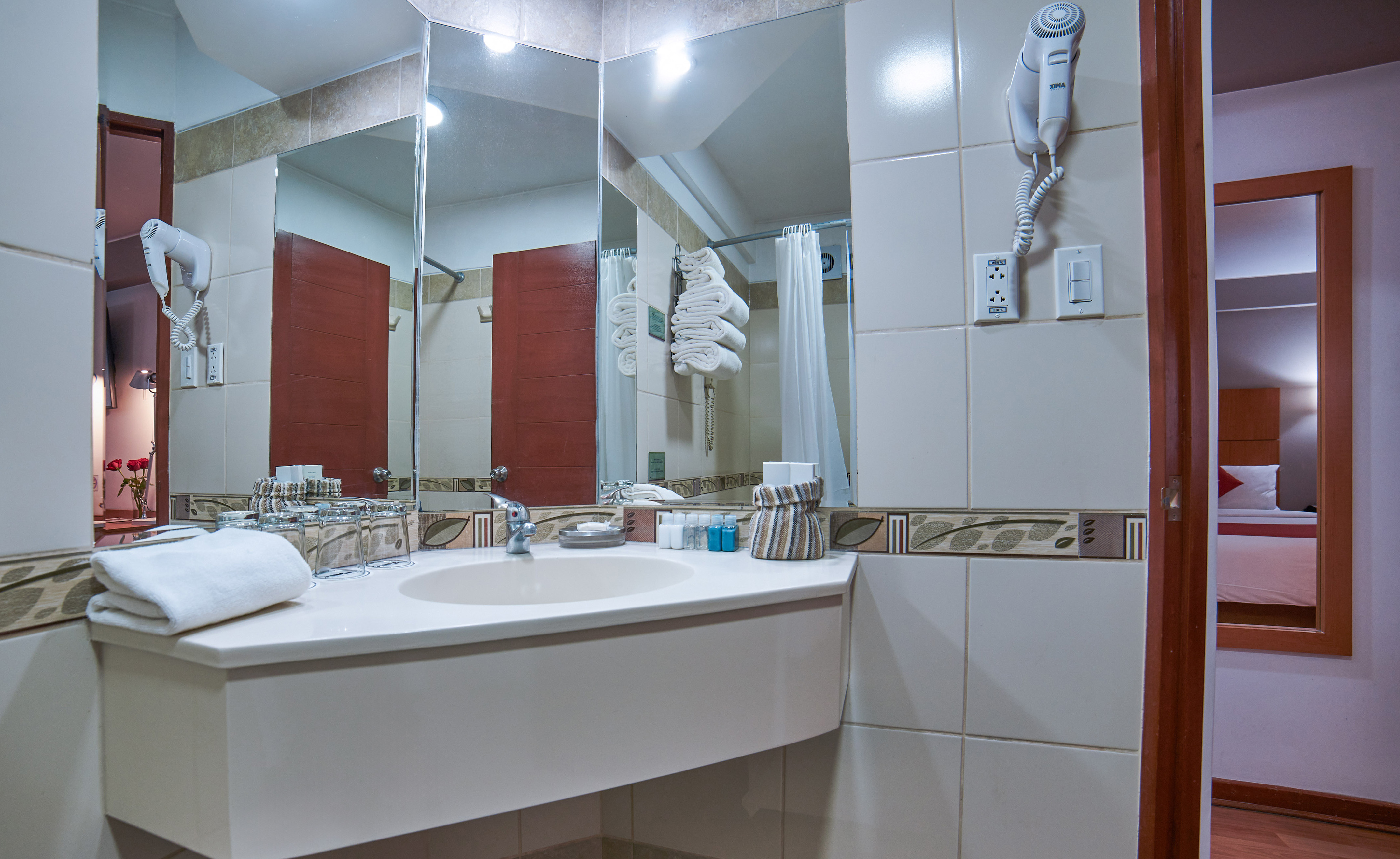 a bathroom with a mirror and a sink