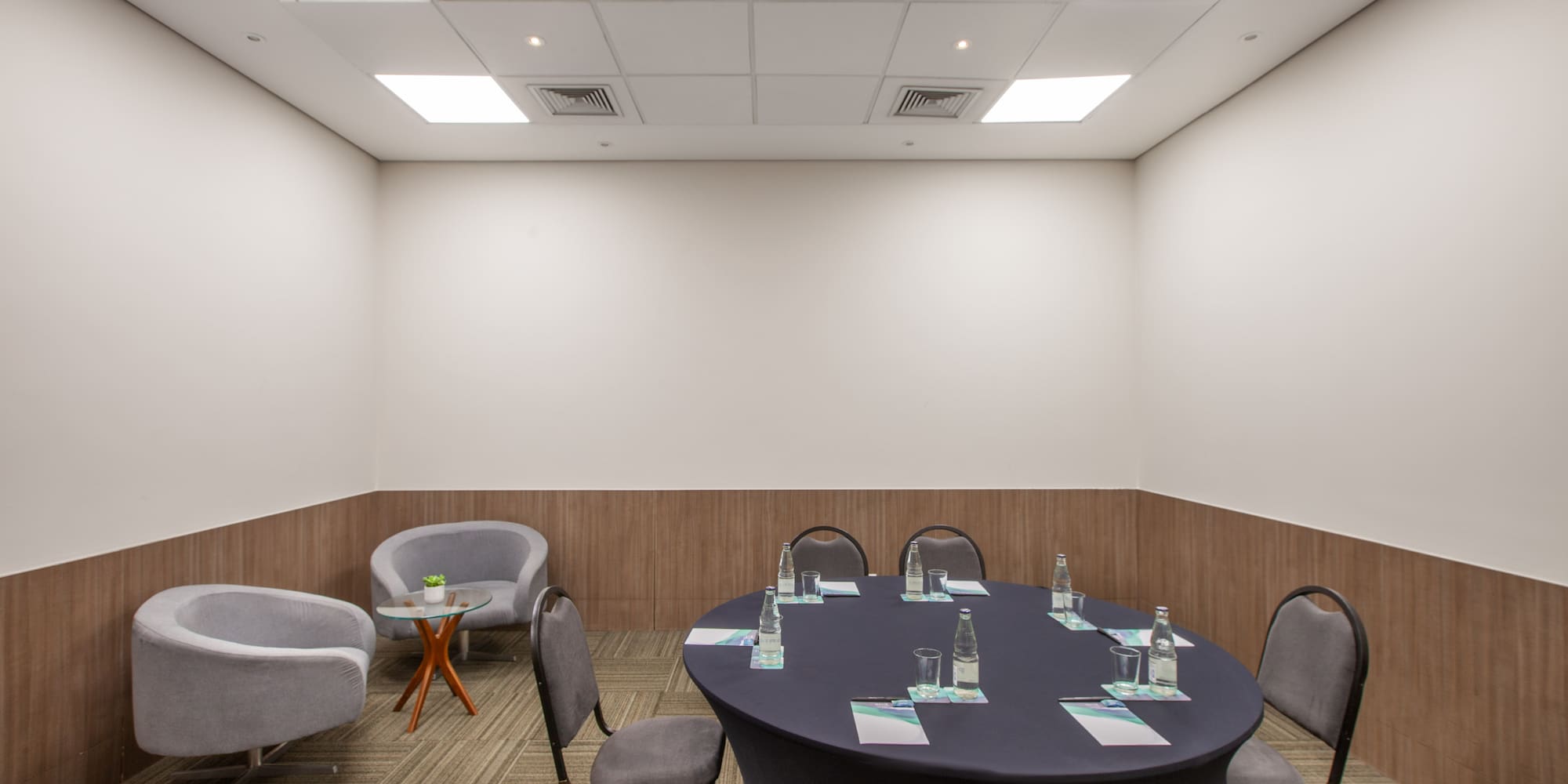 a room with a round table and chairs