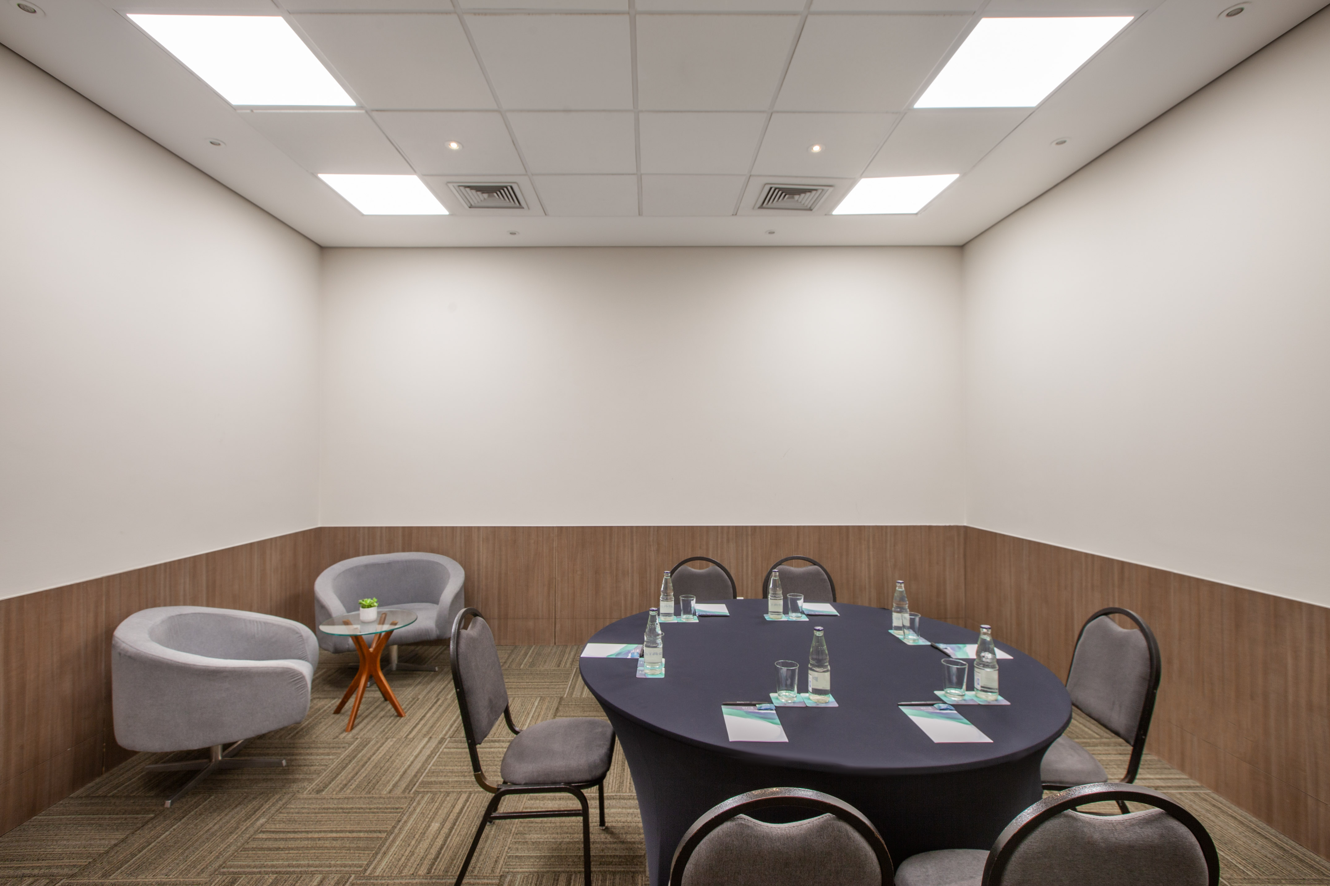 a room with a round table and chairs