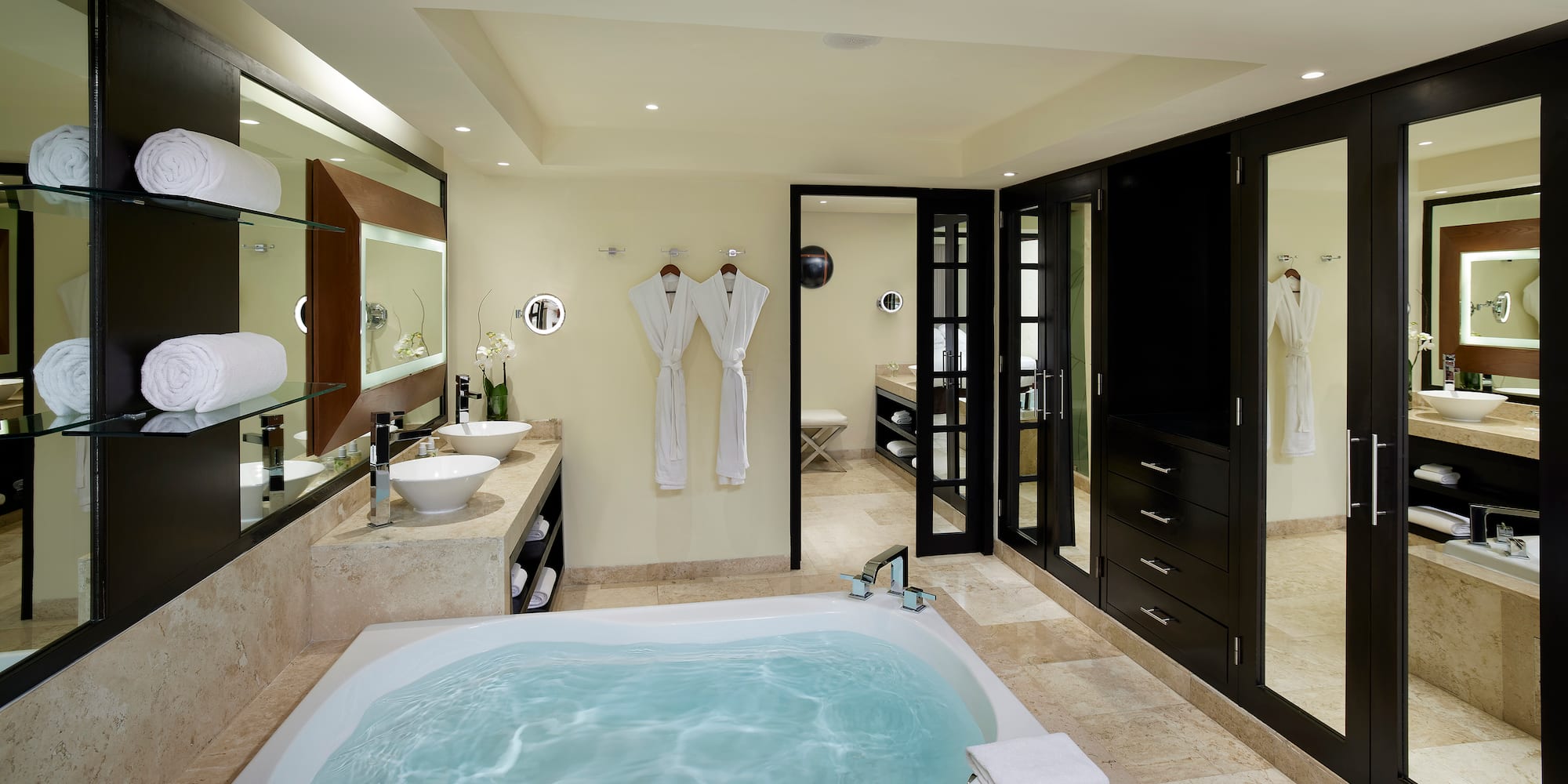 a bathroom with a tub and sinks