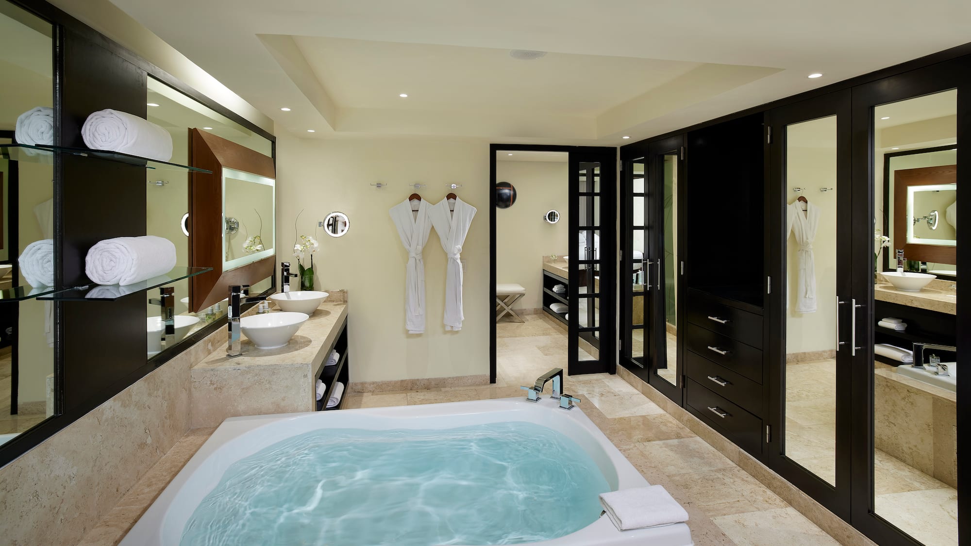 a bathroom with a tub and sinks