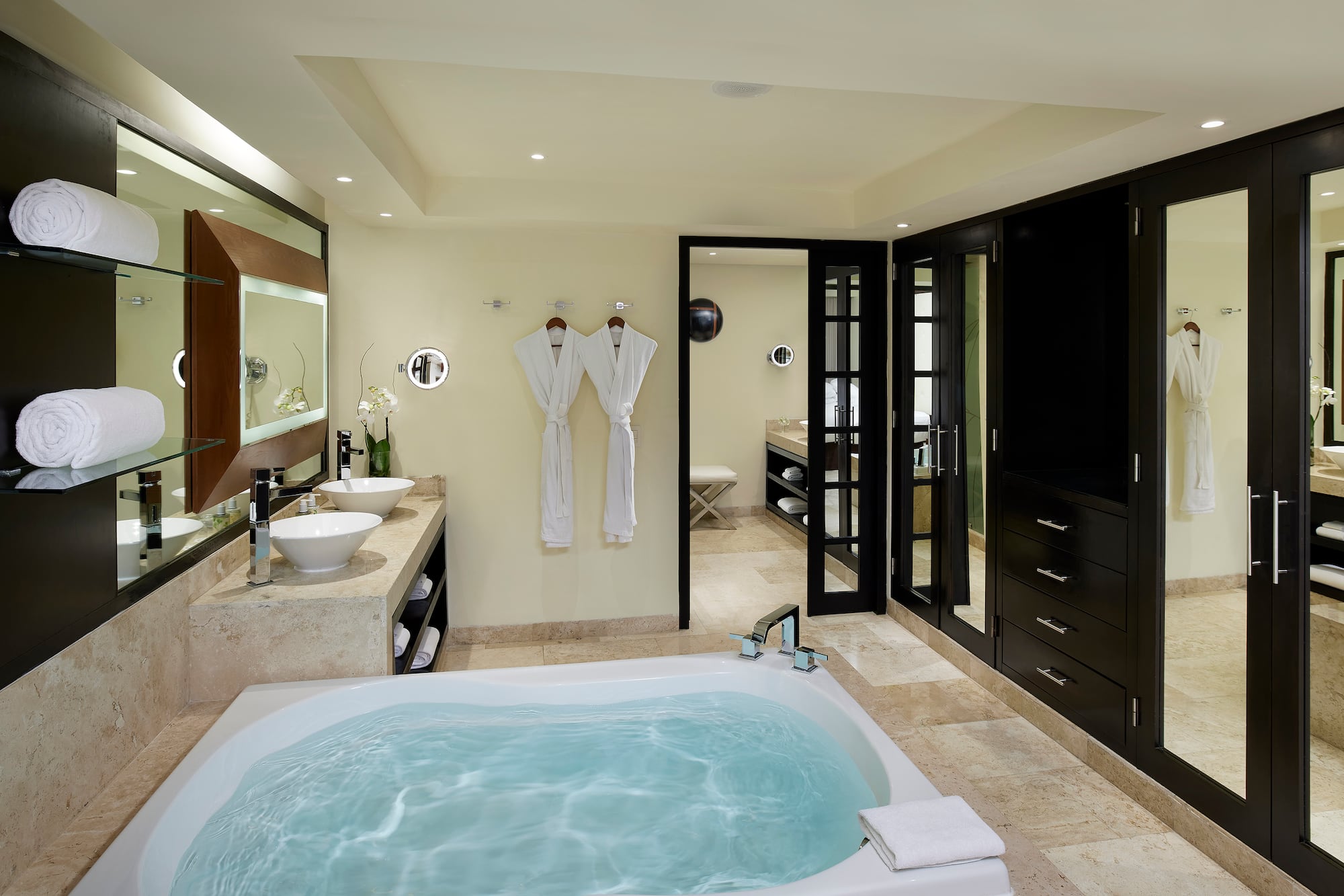 a bathroom with a tub and sinks