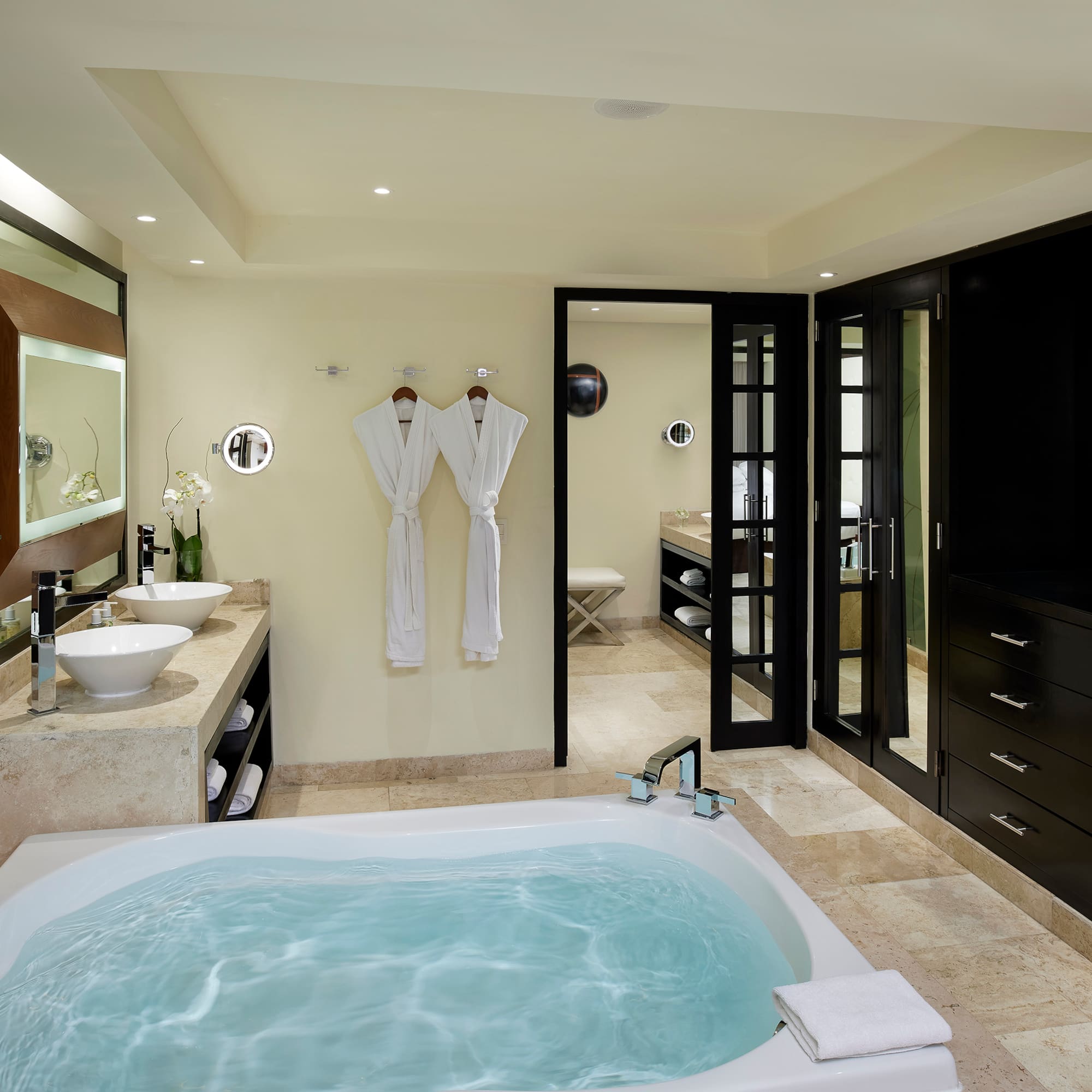 a bathroom with a tub and sinks