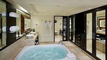 a bathroom with a tub and sinks
