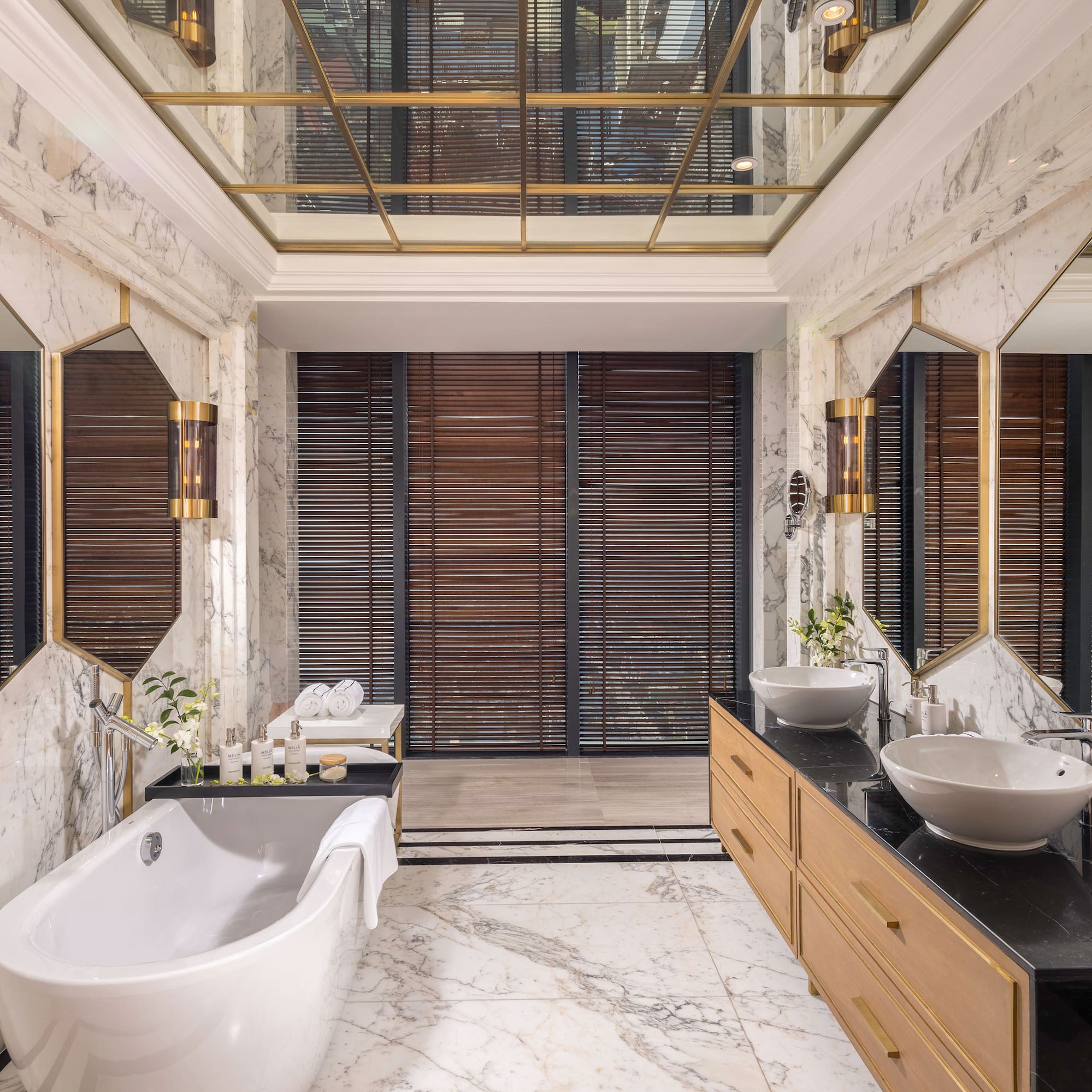 a bathroom with marble walls and a tub